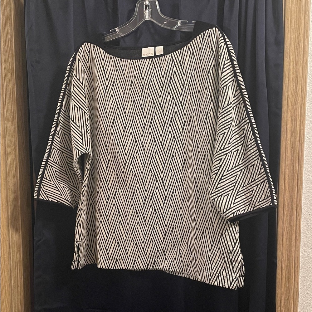 Chico’s women’s boar neck top. Size 2, black and cream diamond jacquard design.